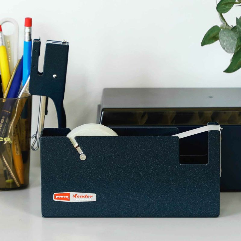 A large blue metal tape disperser from the Pencil Me In stationery shop.