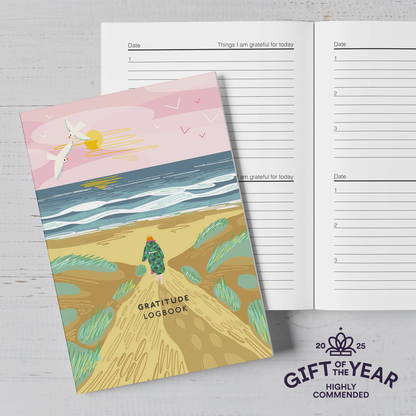 A gratitude logbook with an image on a woman on the beach from the Pencil Me In stationery shop.