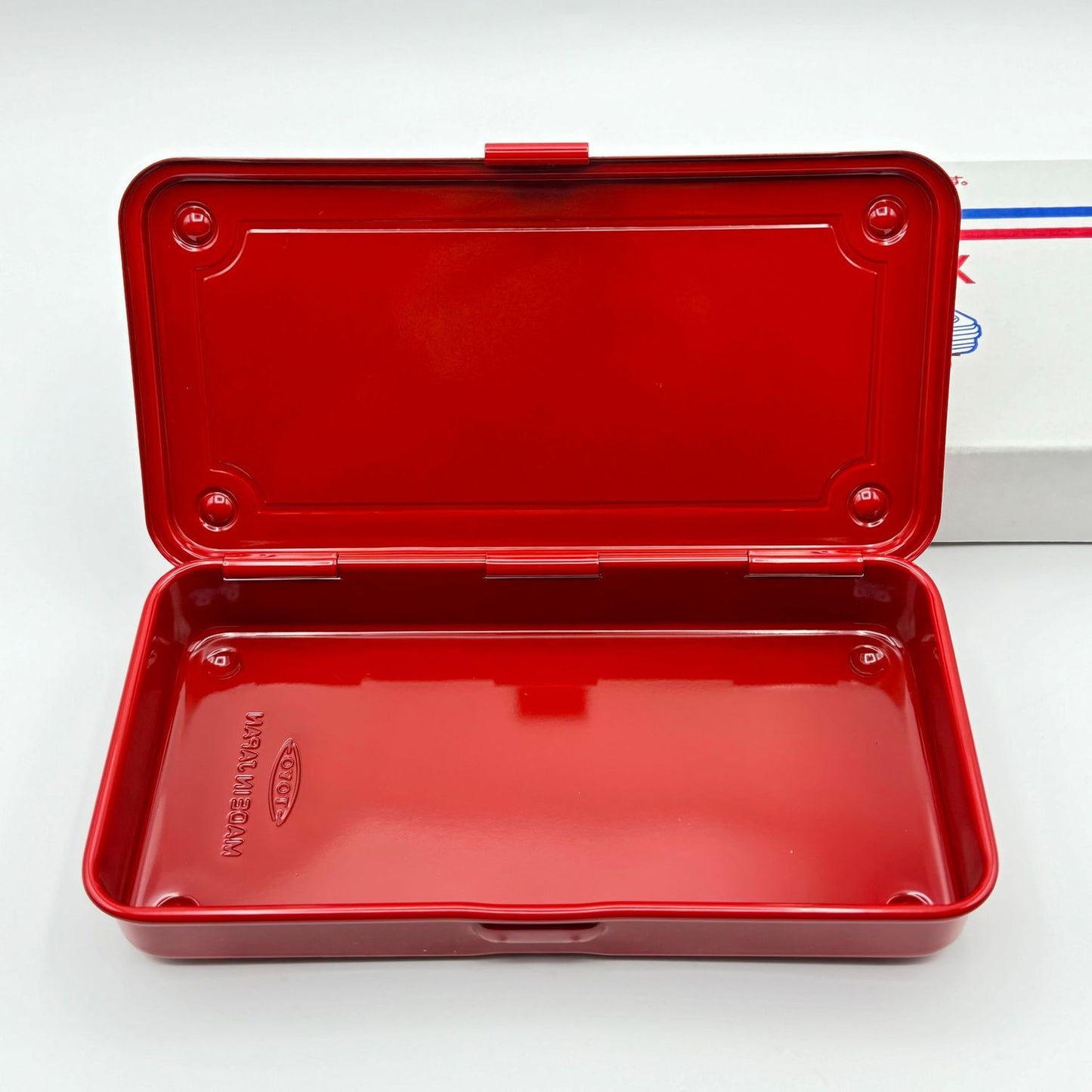 A slim red toolbox from the Pencil Me In stationery shop.