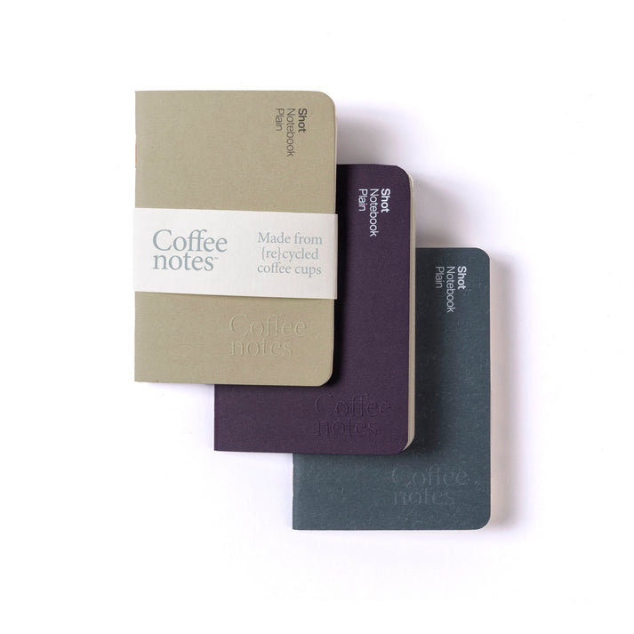 A selection of 3 pocket notebooks in beige, purple and navy from the Pencil Me In stationery shop.