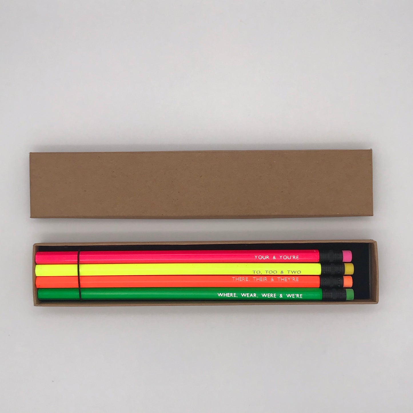 A foil printed set of grammar pencils in a gift box from the Pencil Me In stationery shop reading ‘YOUR & YOU'RE’. A foil printed set of grammar pencils in a gift box from the Pencil Me In stationery shop reading ‘TO, TOO & TWO’. A foil printed set of grammar pencils in a gift box from the Pencil Me In stationery shop reading ‘THERE, THEIR & THEY'RE’. A foil printed set of grammar pencils in a gift box from the Pencil Me In stationery shop reading ‘WHERE, WEAR, WERE & WE'RE’.