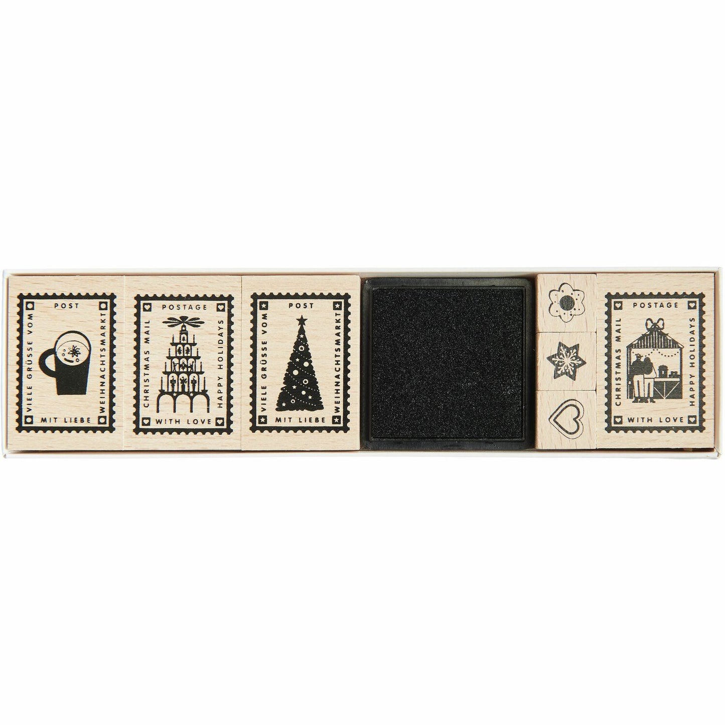 A selection of Christmas stamps with a black ink pad from the Pencil Me In stationery shop.