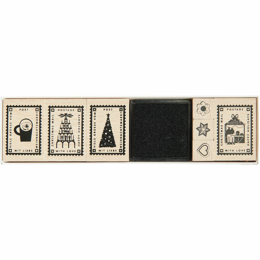 A selection of Christmas stamps with a black ink pad from the Pencil Me In stationery shop.