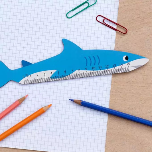 A wooden ruler in the shape of a shark from the Pencil Me In stationery shop. 