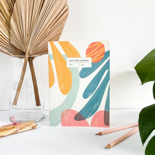 Notebook with abstract design on a white surface with decorative elements