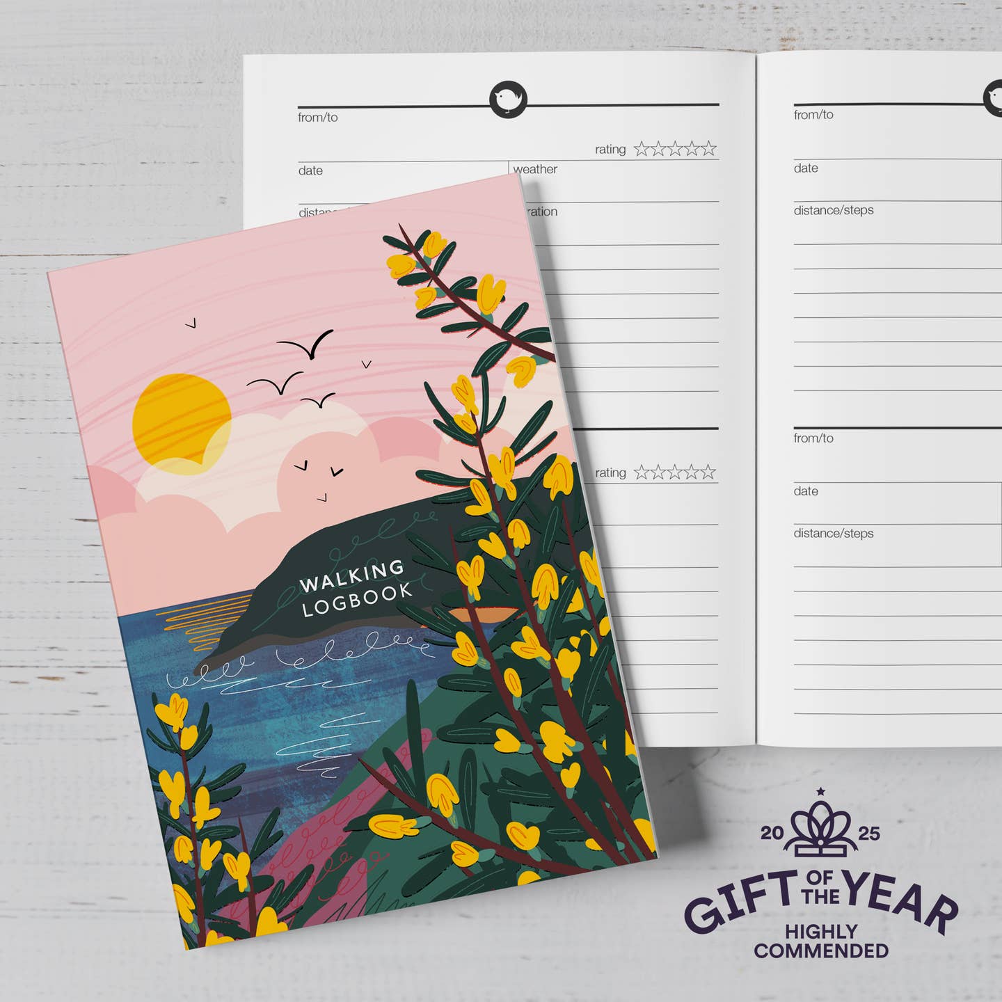 A Walking Logbook with a scenic design of a sunset over water and yellow flowers from the Pencil Me In stationery shop.