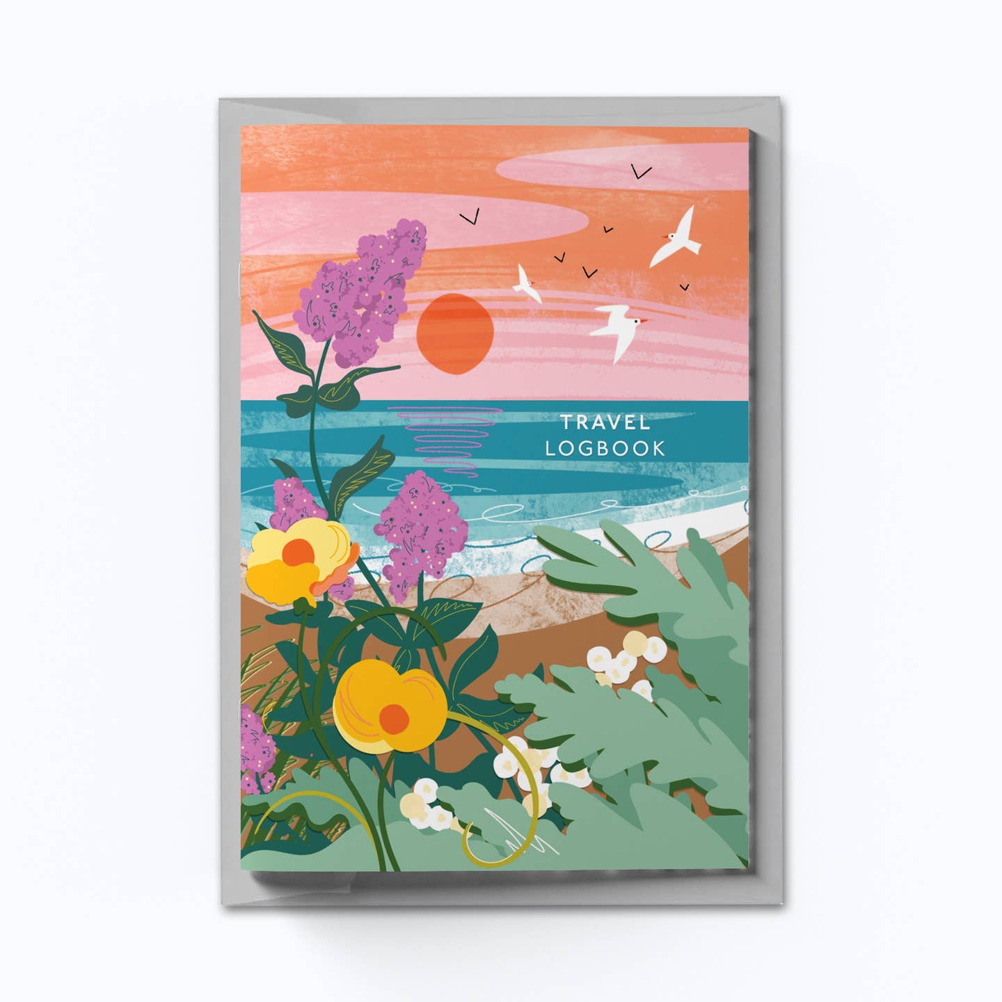 A travel logbook with a colorful beach scene and flowers from the Pencil Me In stationery shop. 