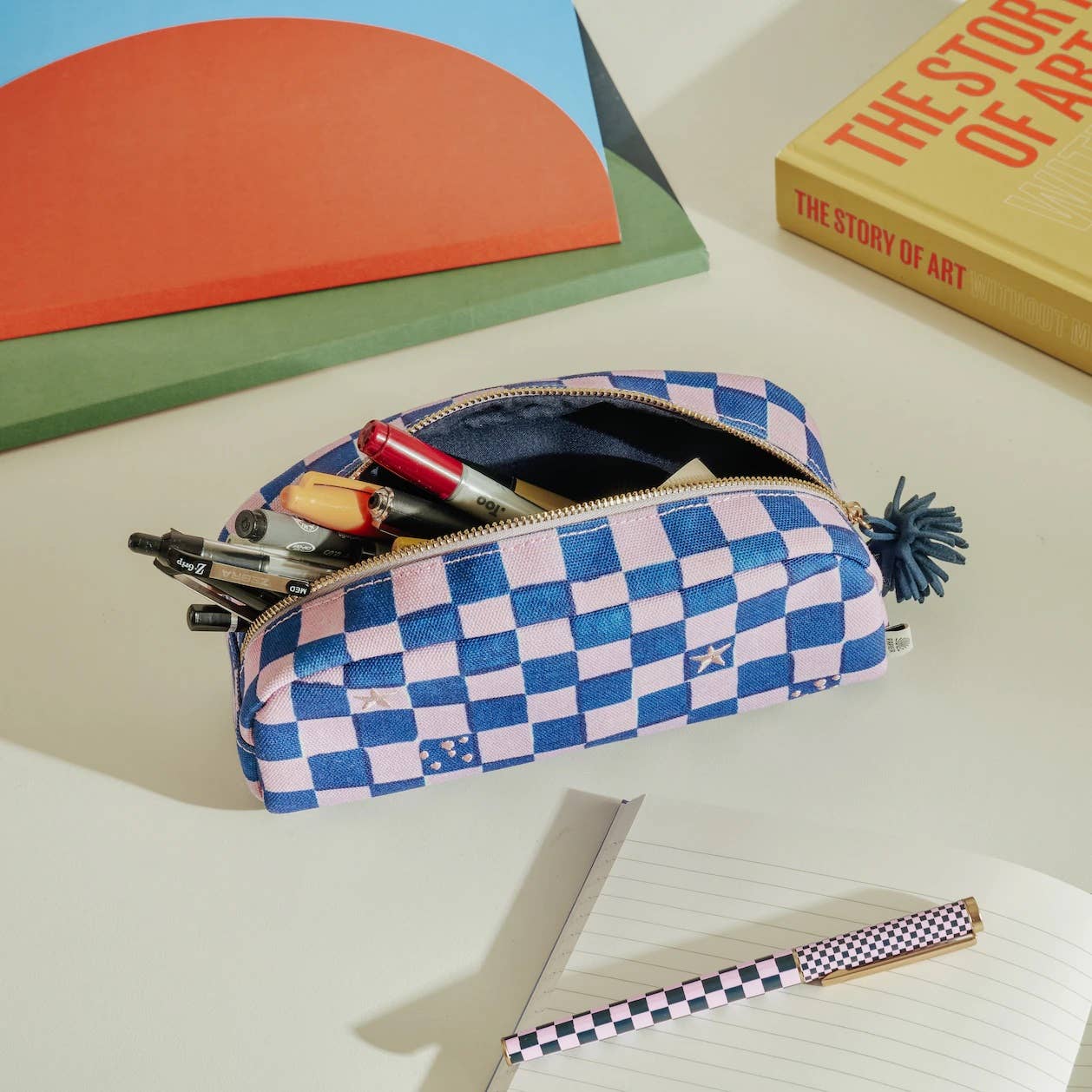 A purple checkerboard pencil case from the Pencil Me In stationery shop. 
