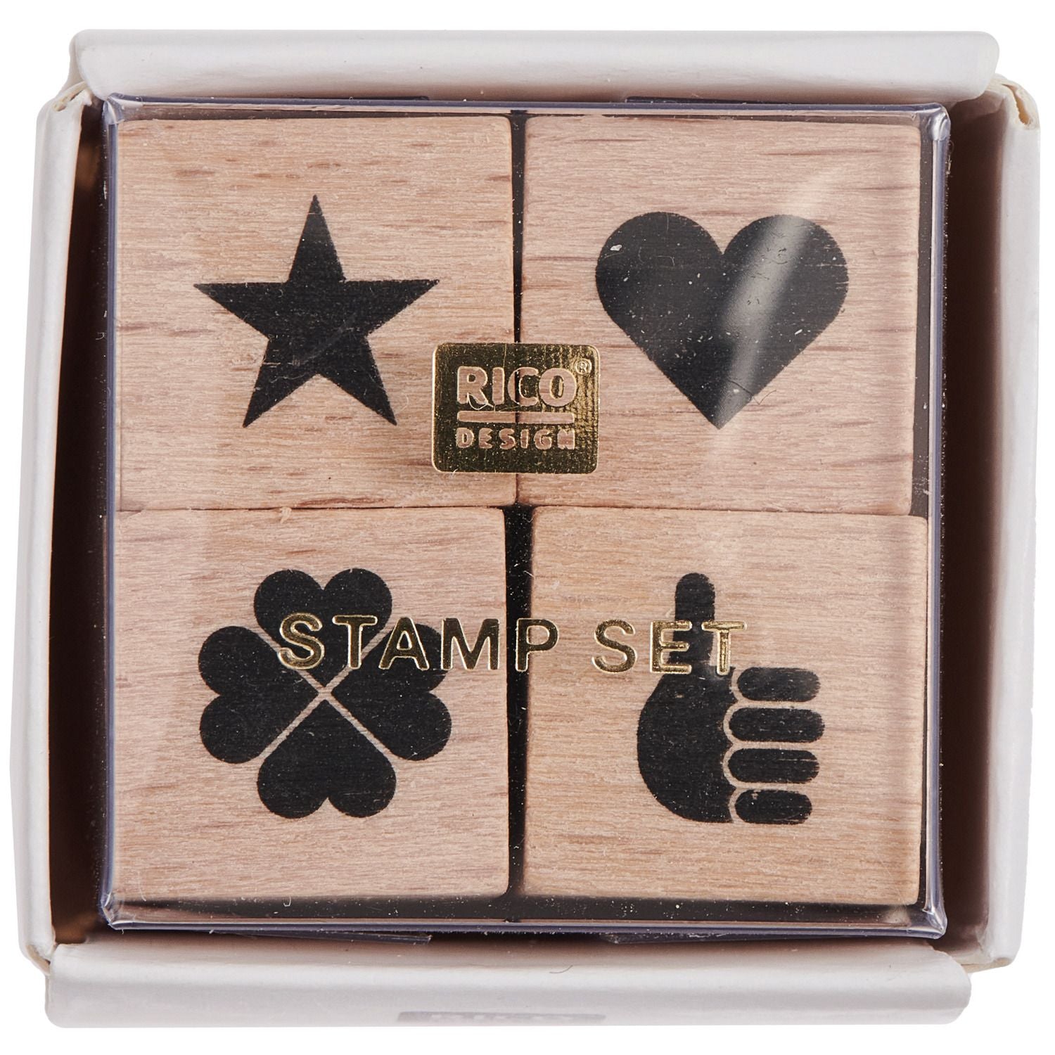 A set of four wooden stamps with star, heart, clover, and hand symbols in a box from the Pencil Me In stationery shop. 