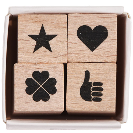A set of four wooden stamps with star, heart, clover, and hand symbols in a box from the Pencil Me In stationery shop. 