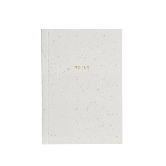 A white notebook with 'NOTES' text on the front from the Pencil Me In stationery shop. 