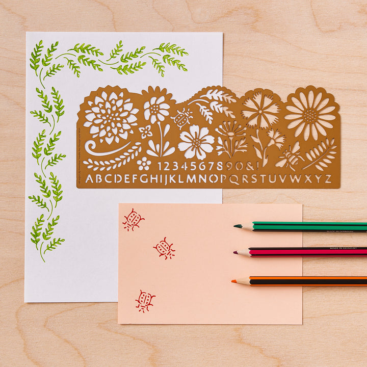 A decorative stencil with floral, alphabet and number designs from the Pencil Me In stationery shop. 