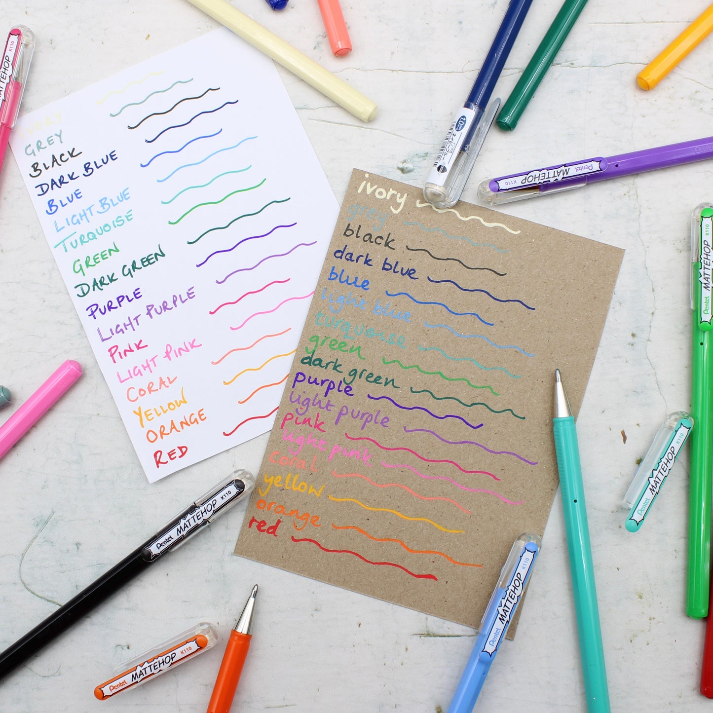 Color swatches and markers on a white surface from the Pencil Me In stationery shop.