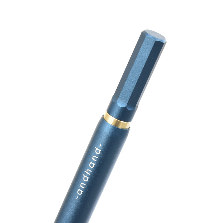 A blue pen with gold accents from the Pencil Me In stationery shop.