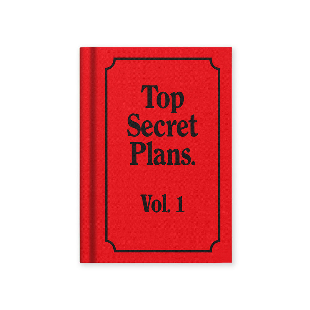 A Red book titled 'Top Secret Plans Vol. 1' from the Pencil Me In stationery shop. 