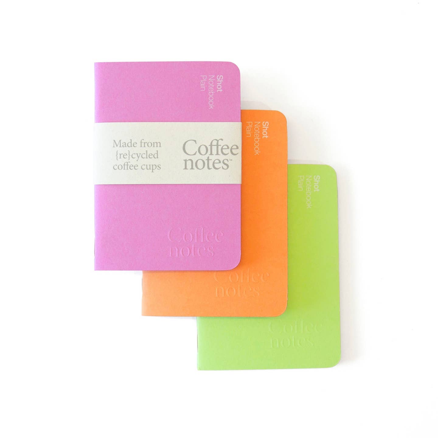 A selection of 3 pocket notebooks in pink, orange and green from the Pencil Me In stationery shop. 