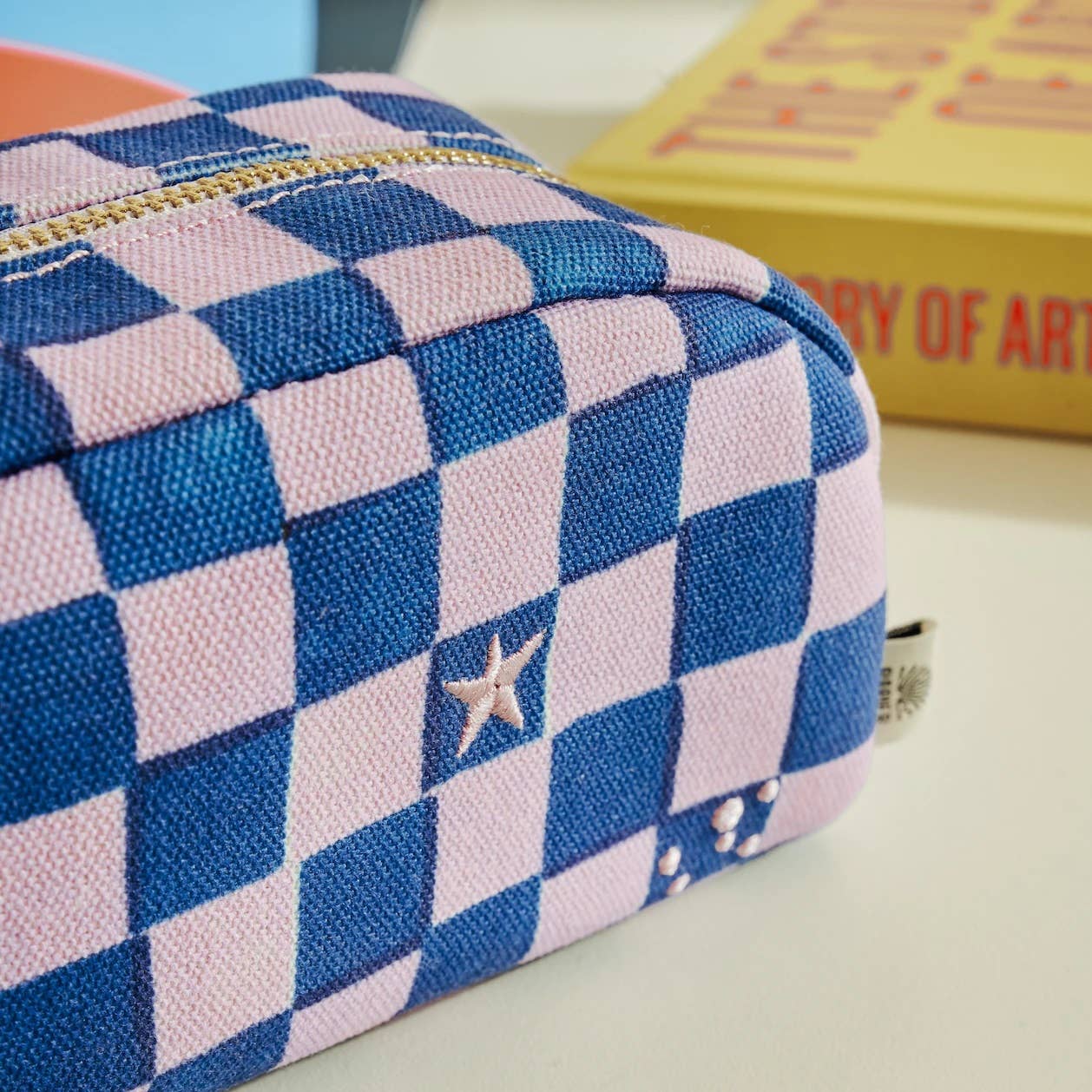 A purple checkerboard pencil case from the Pencil Me In stationery shop. 