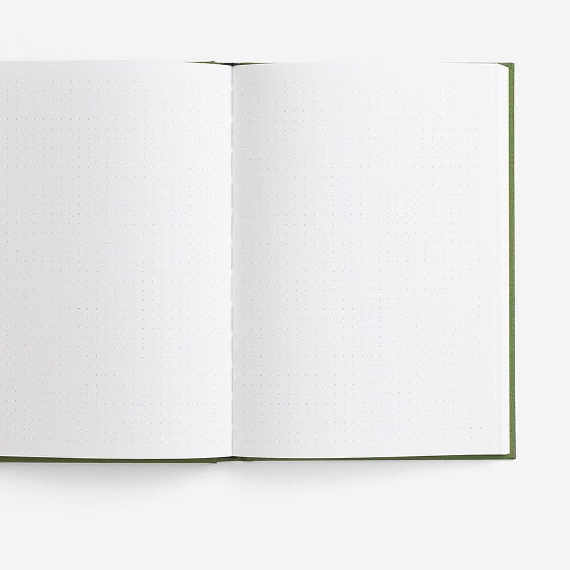 A open notebook with green binding and grid dot paper from the Pencil Me In stationery shop.