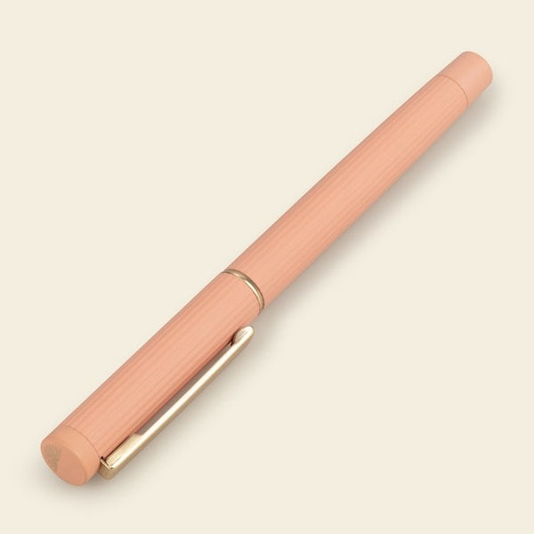 A peach rollerball pen from the Pencil Me In stationery shop.