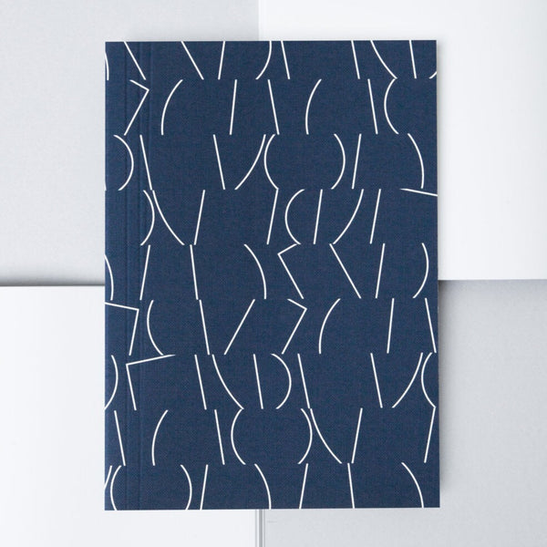 Navy and white line patterned cove notebook from the Pencil Me  In stationery shop.